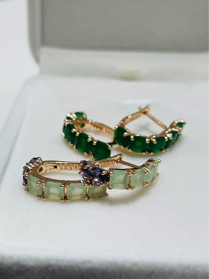 14k rolled gold huggie hoop earrings with a beautiful combination of green and purple gemstones.