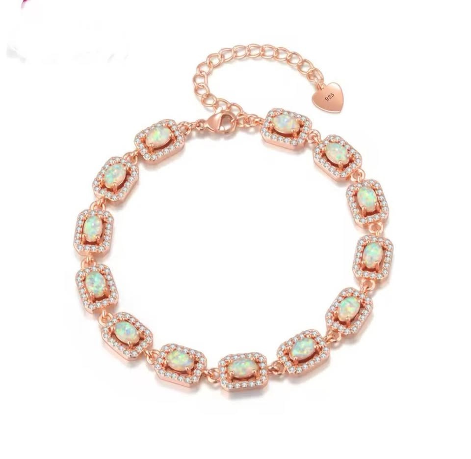 Luxurious 14K rose gold hoop earrings adorned with alternating rows of deep blue sapphires and white cubic zirconia.