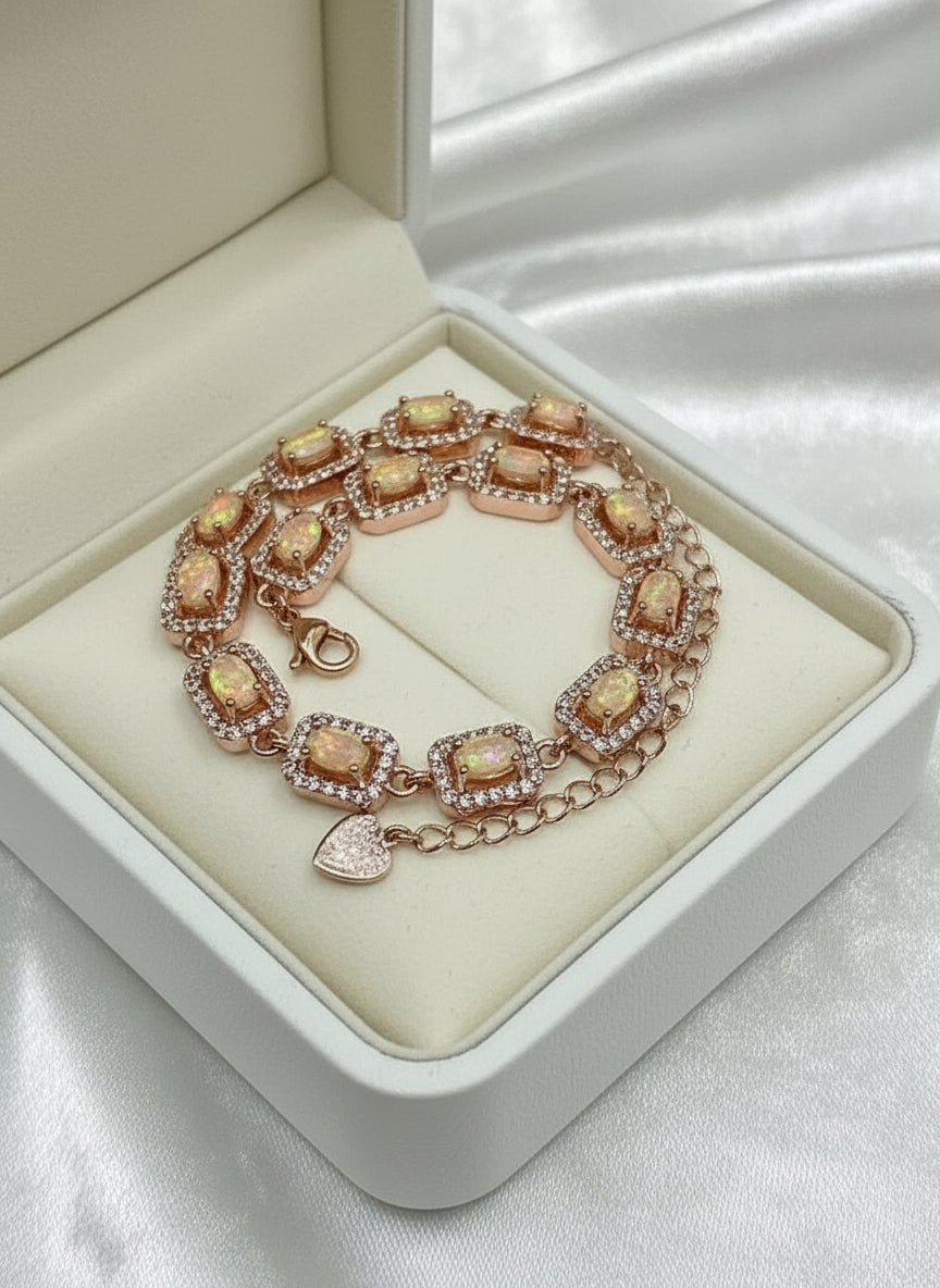 Exquisite rose gold-plated sterling silver bracelet featuring rectangular created opal links, displayed in a red box.