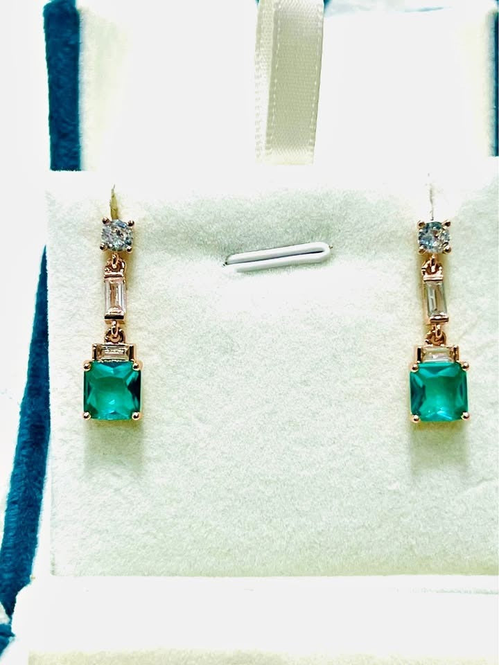 Elegant sterling silver, rose gold-filled dangle earrings with vibrant green topaz and sparkling white stones.