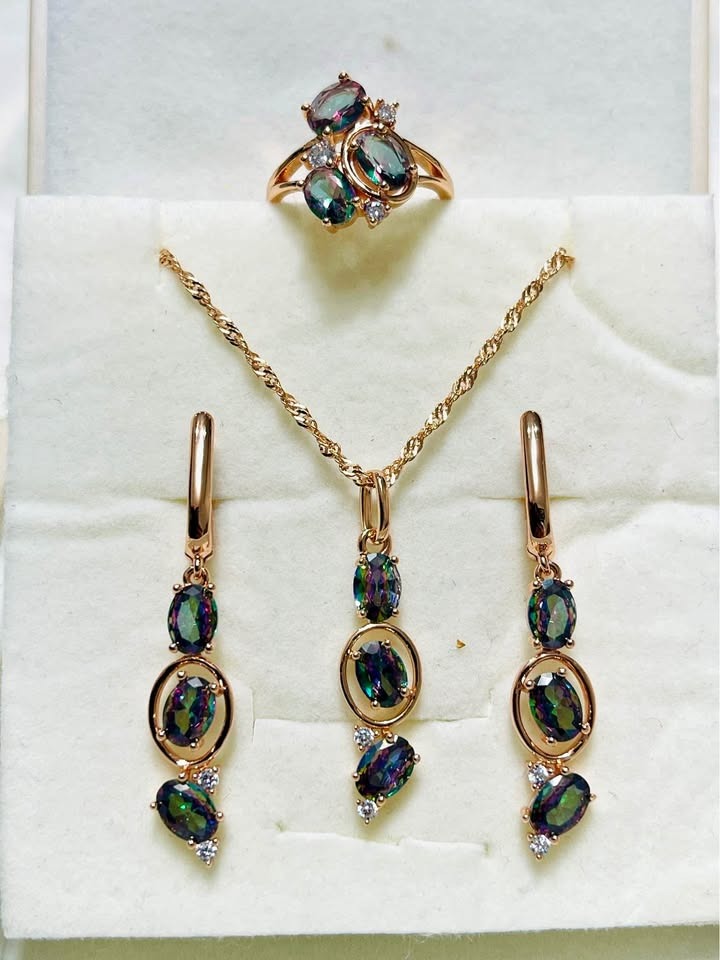Complete rose gold jewelry set with iridescent mystic topaz gemstones including a ring, necklace, and earrings.