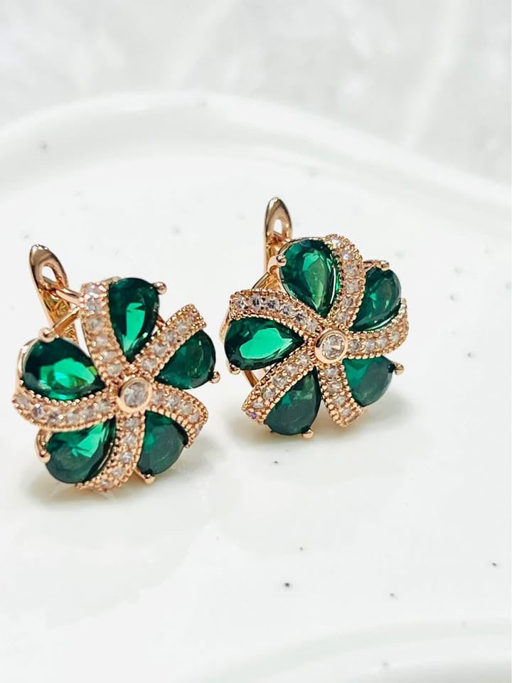  Pair of 14K rose gold earrings with green topaz floral clusters and sparkling accents.