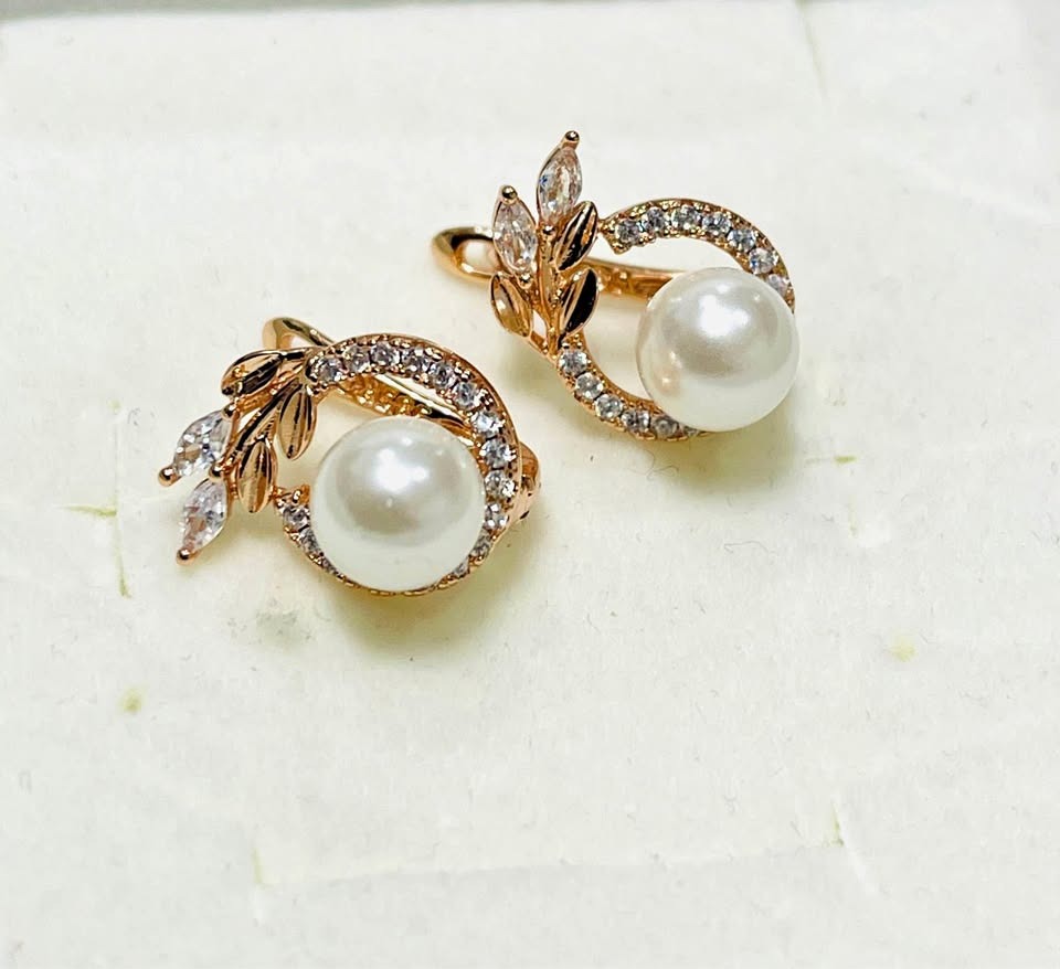 Front view of elegant 14K equivalent rose gold earrings with lustrous pearls and sparkling zircons.