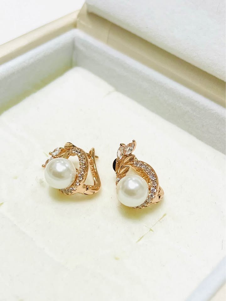 Side view of 14K equivalent rose gold earrings featuring elegant pearls and shimmering zircon accents.