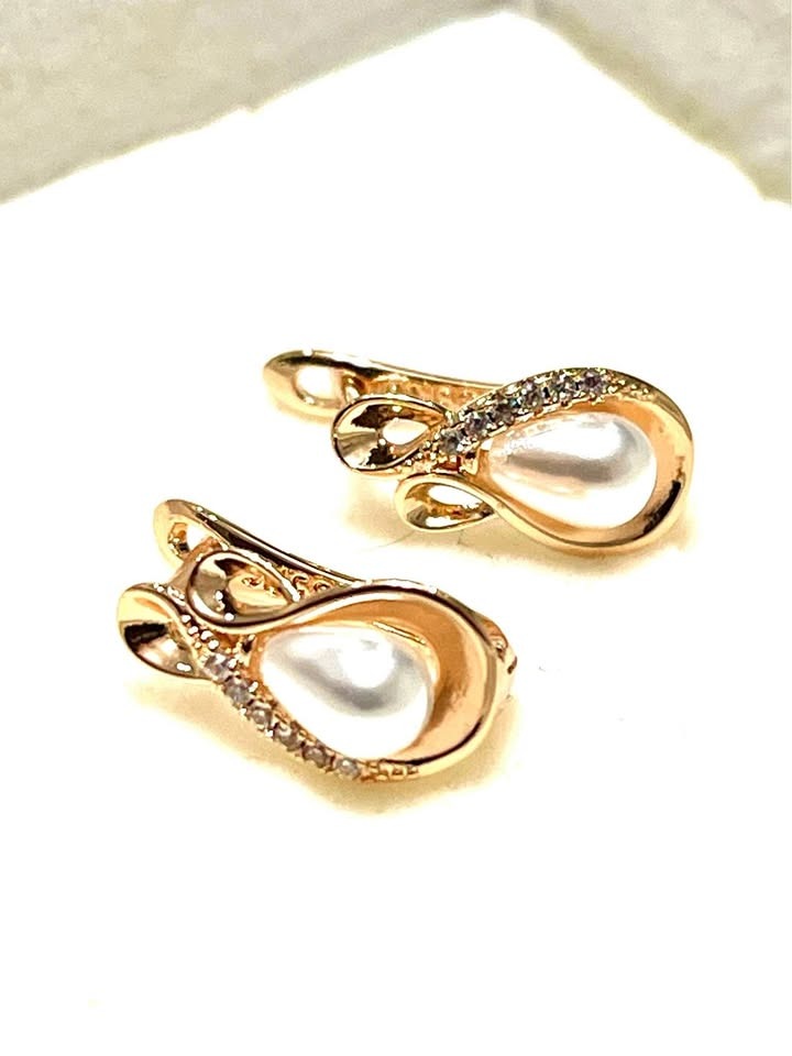 Pair of 585RG stamped 14K equivalent rose gold earrings with teardrop pearls and cubic zirconia accents.