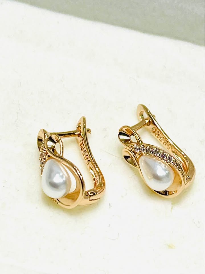 585RG stamped 14K equivalent rose gold earrings with teardrop pearls, showing stamp detail.
