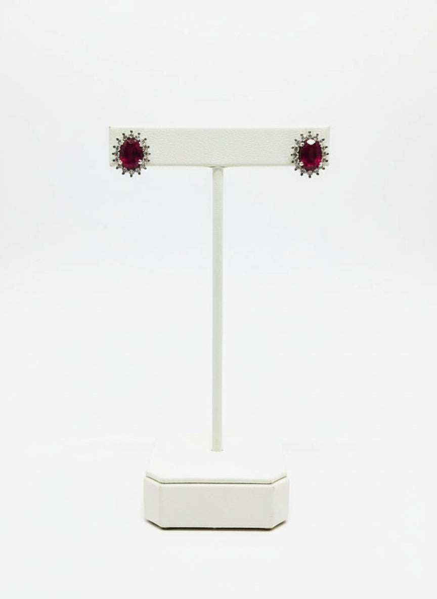  A pair of brilliant ruby and diamond small stud earrings presented beautifully in an open gift box.