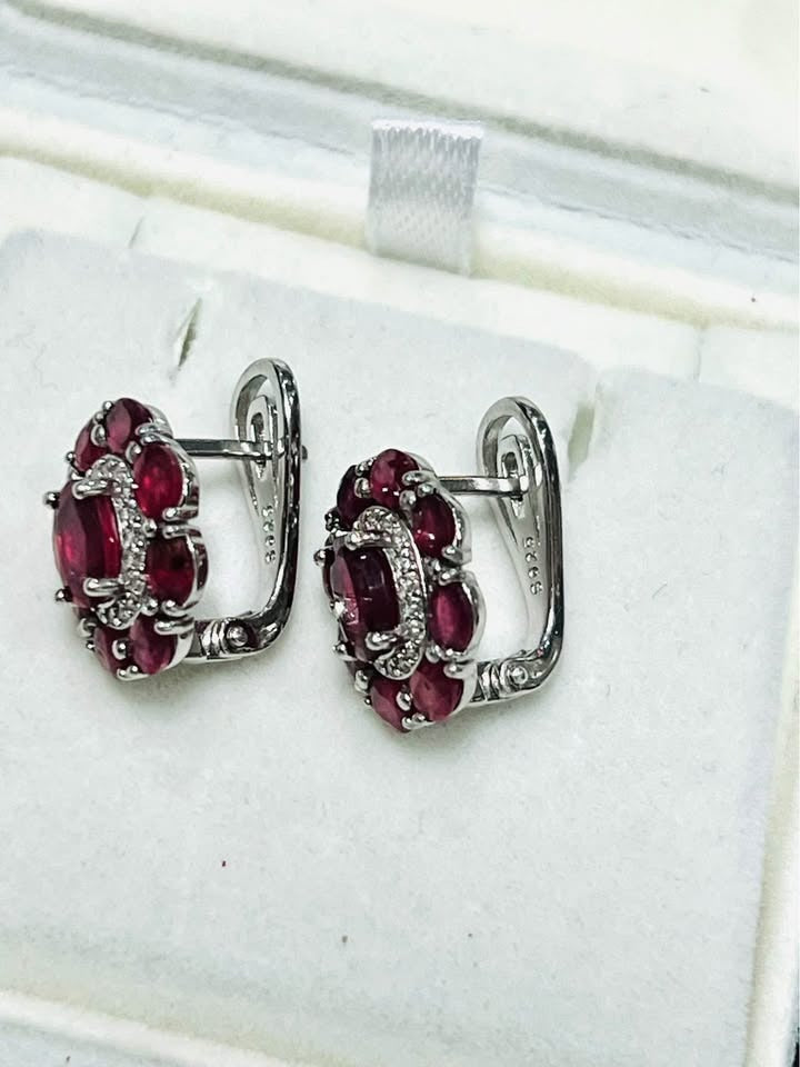 Detailed view of ruby earrings with elegant leverback closure, white gold-plated sterling silver