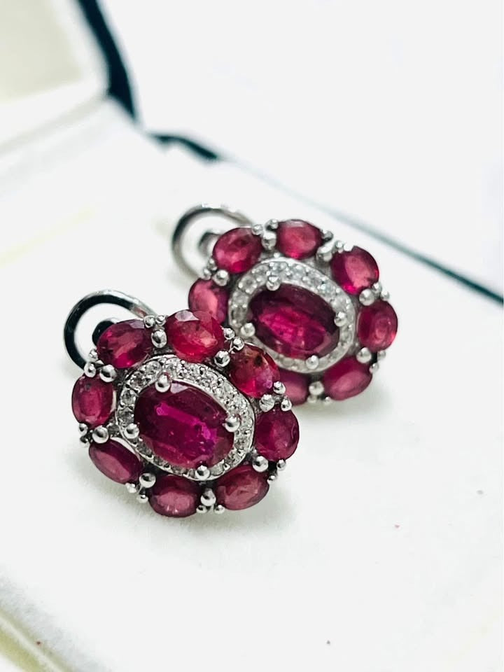 Dazzling ruby earrings set in white gold-plated sterling silver, perfect for special occasions.