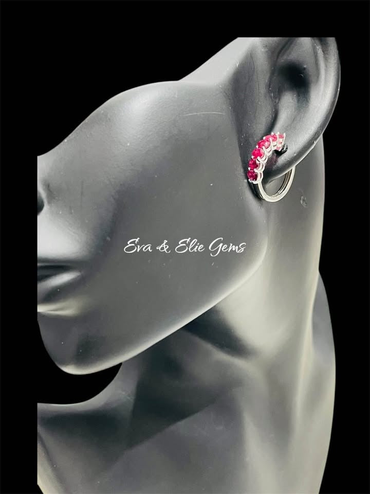 Side view of a ruby sterling silver huggie hoop earring worn on a black mannequin ear, elegant and subtle
