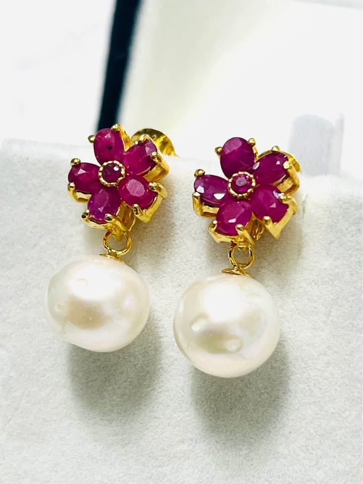 Stunning natural pink ruby earrings with a delicate flower design, featuring genuine South Sea pearl drops.