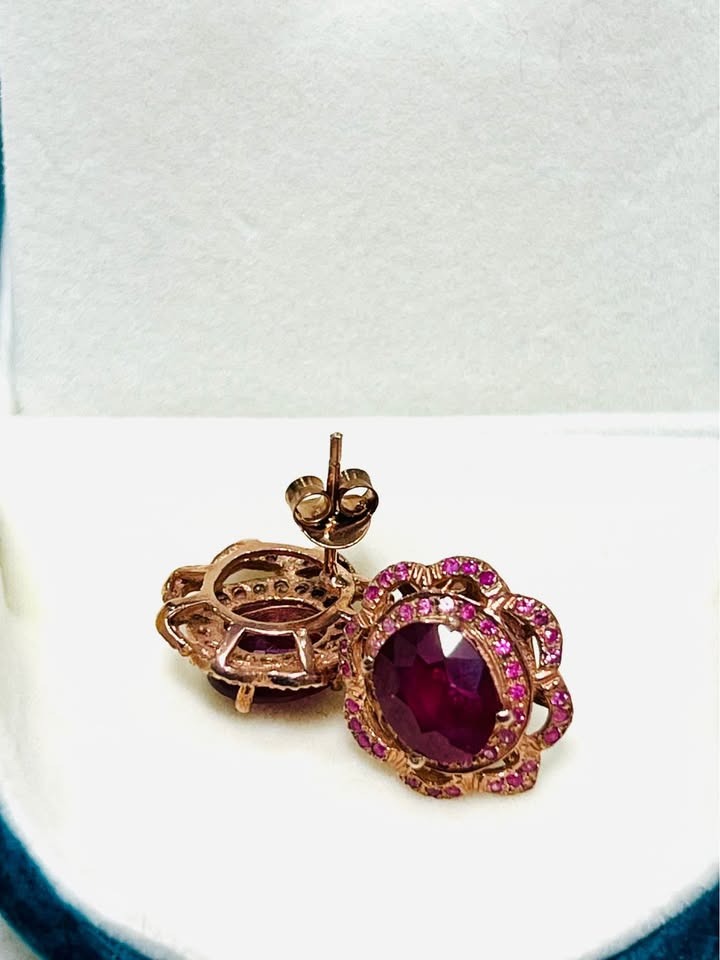 Angled view of ruby and pink sapphire earrings, revealing the rose gold setting and delicate details.
