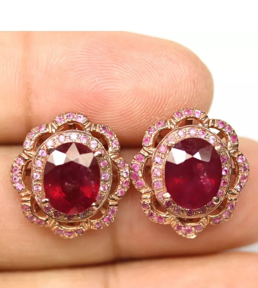 Exquisite ruby and pink sapphire halo earrings, showcasing intricate detail and vibrant gemstones.