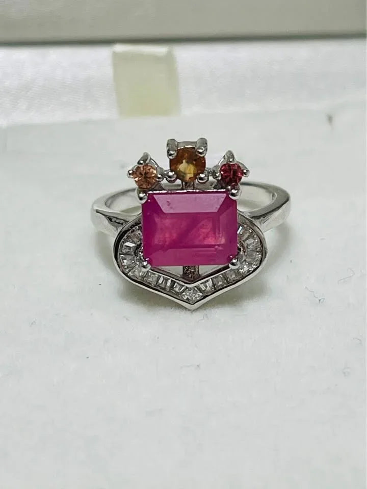 Front view of a 3 carat natural ruby and sapphire ring, featuring a vibrant center stone.