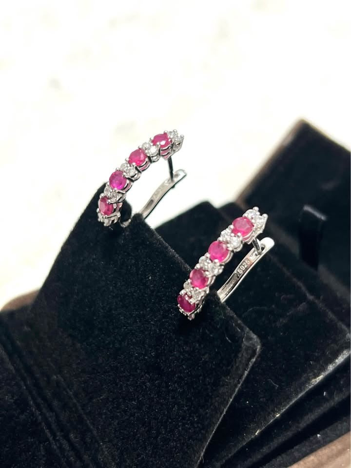 1.40 Cttw pink ruby and white sapphire hoop earrings, 925 sterling silver, on display.
