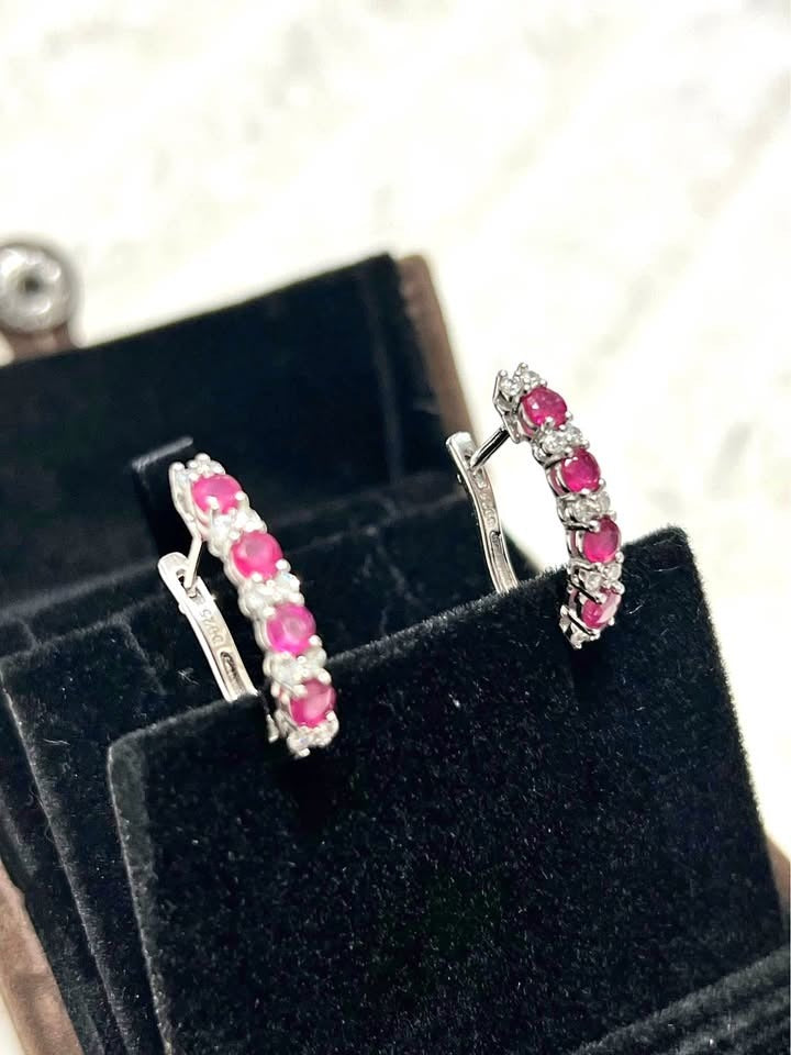 Side angle view of pink ruby & white sapphire 925 sterling silver hoop earrings.