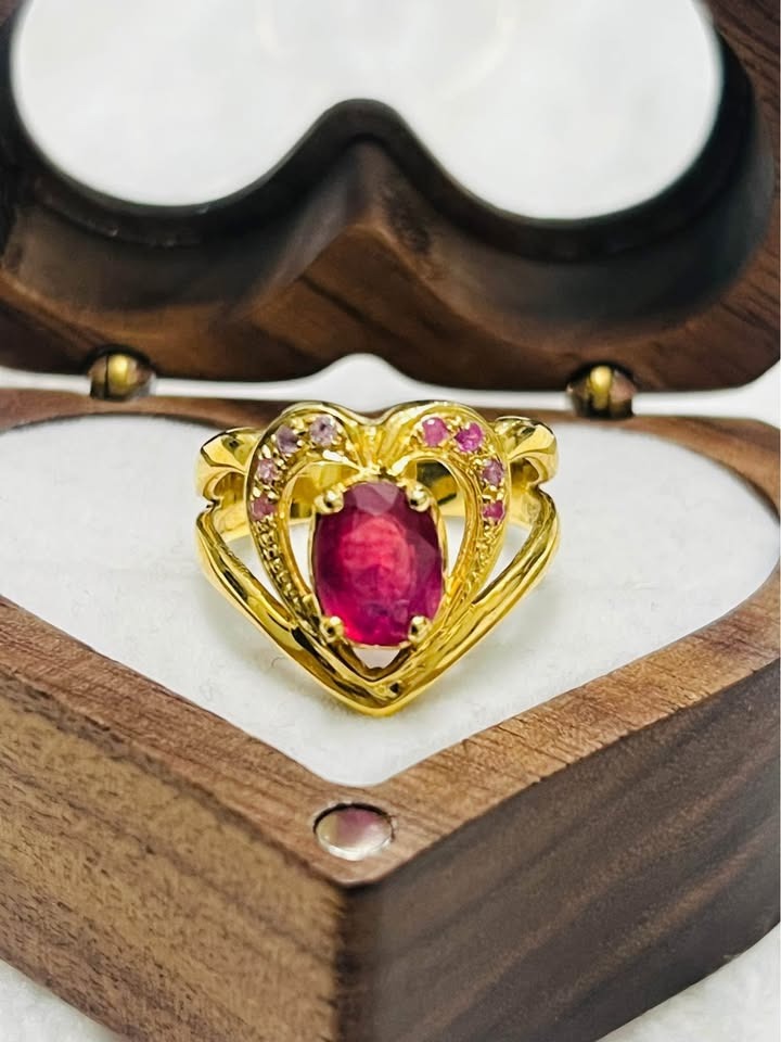 Close-up of genuine ruby heart-shaped sterling silver ring, ideal for engagement or gift.