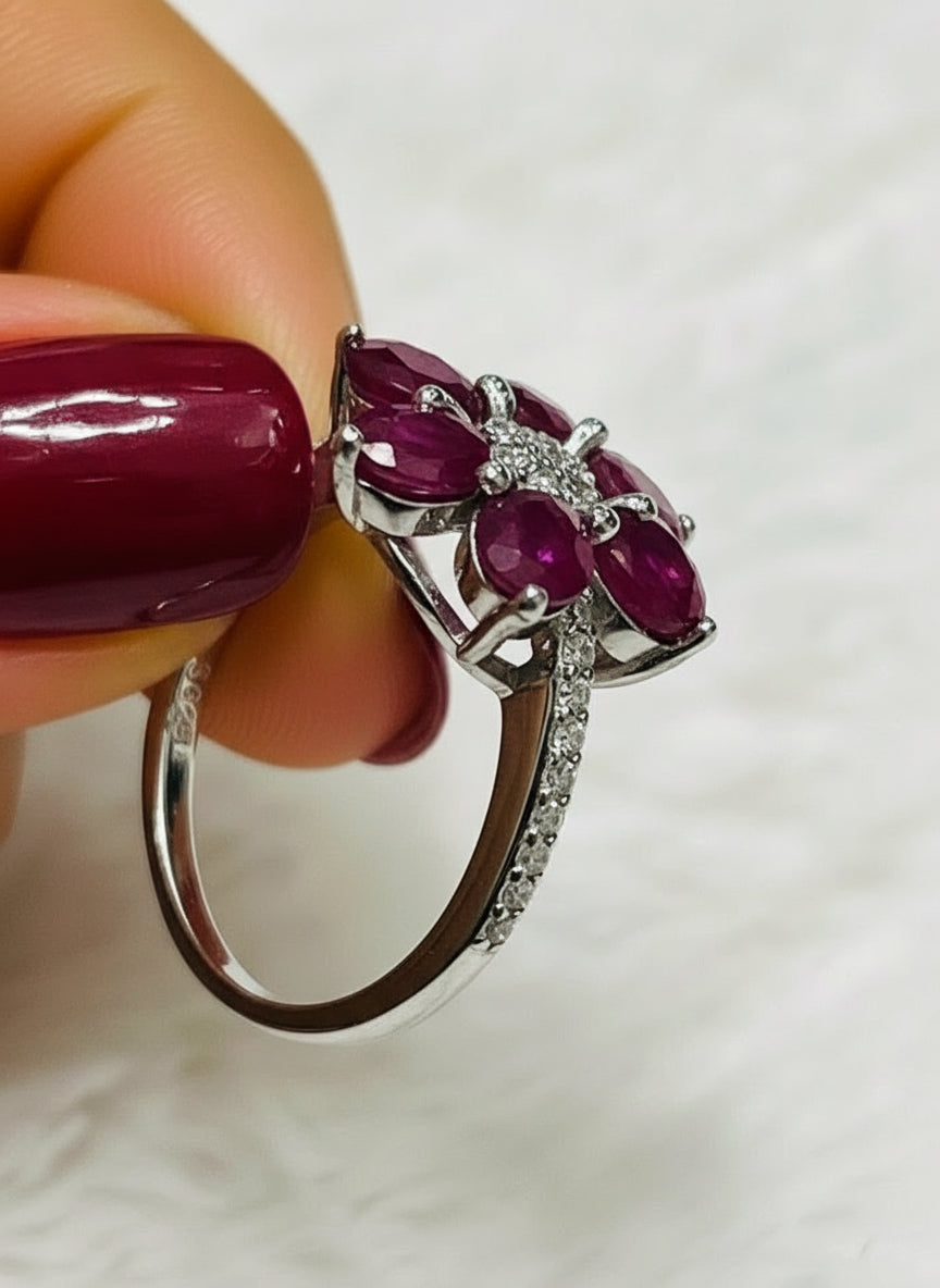 Side profile of a natural ruby flower ring with a visible S925 sterling silver stamp.