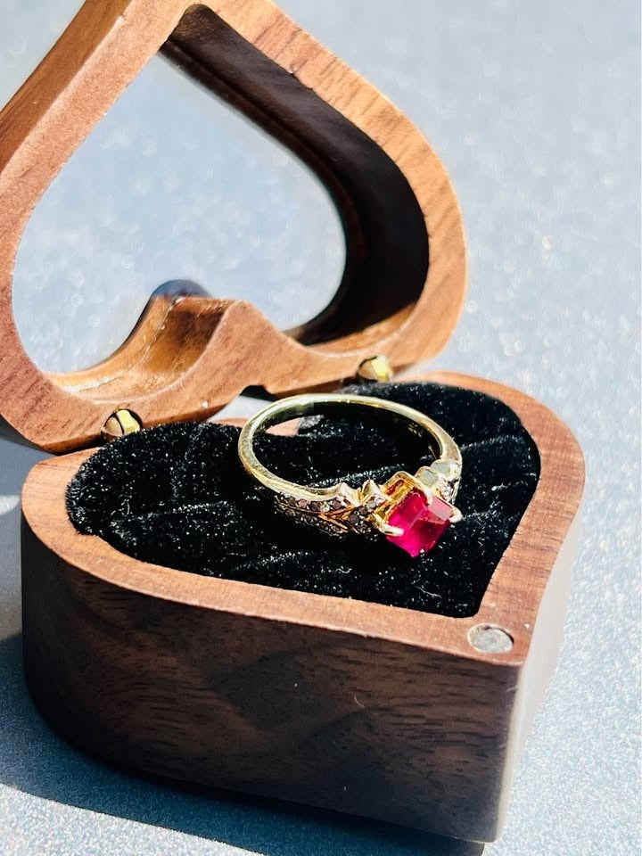  Beautiful natural ruby and diamond ring nestled in a wooden ring box.