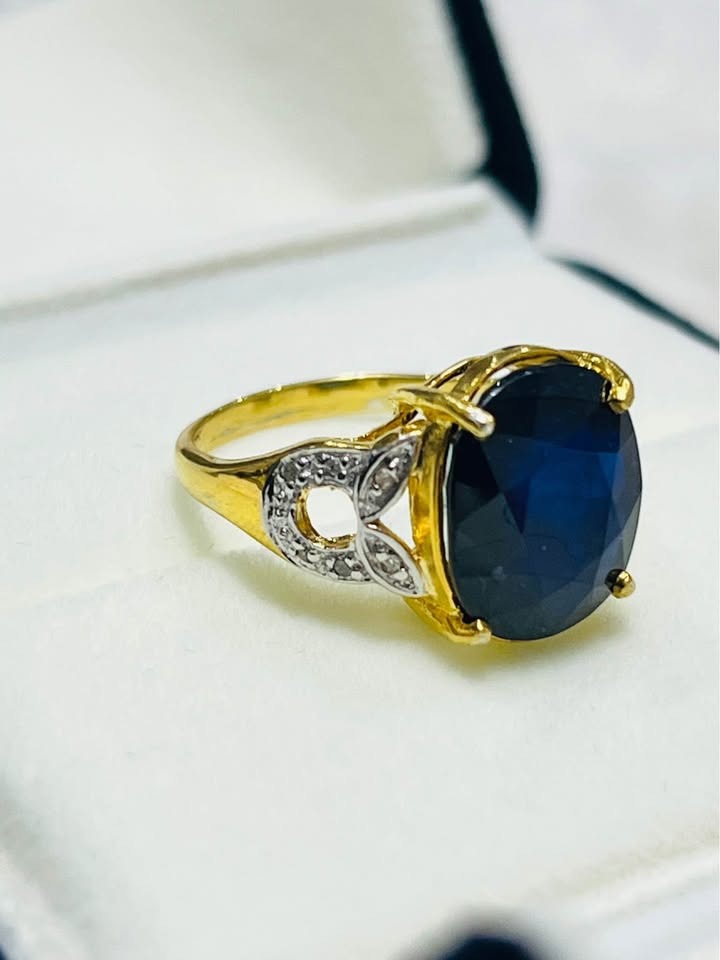  Stunning sterling silver ring featuring a 6 CTW sapphire, natural diamonds, and gold-tone accents.