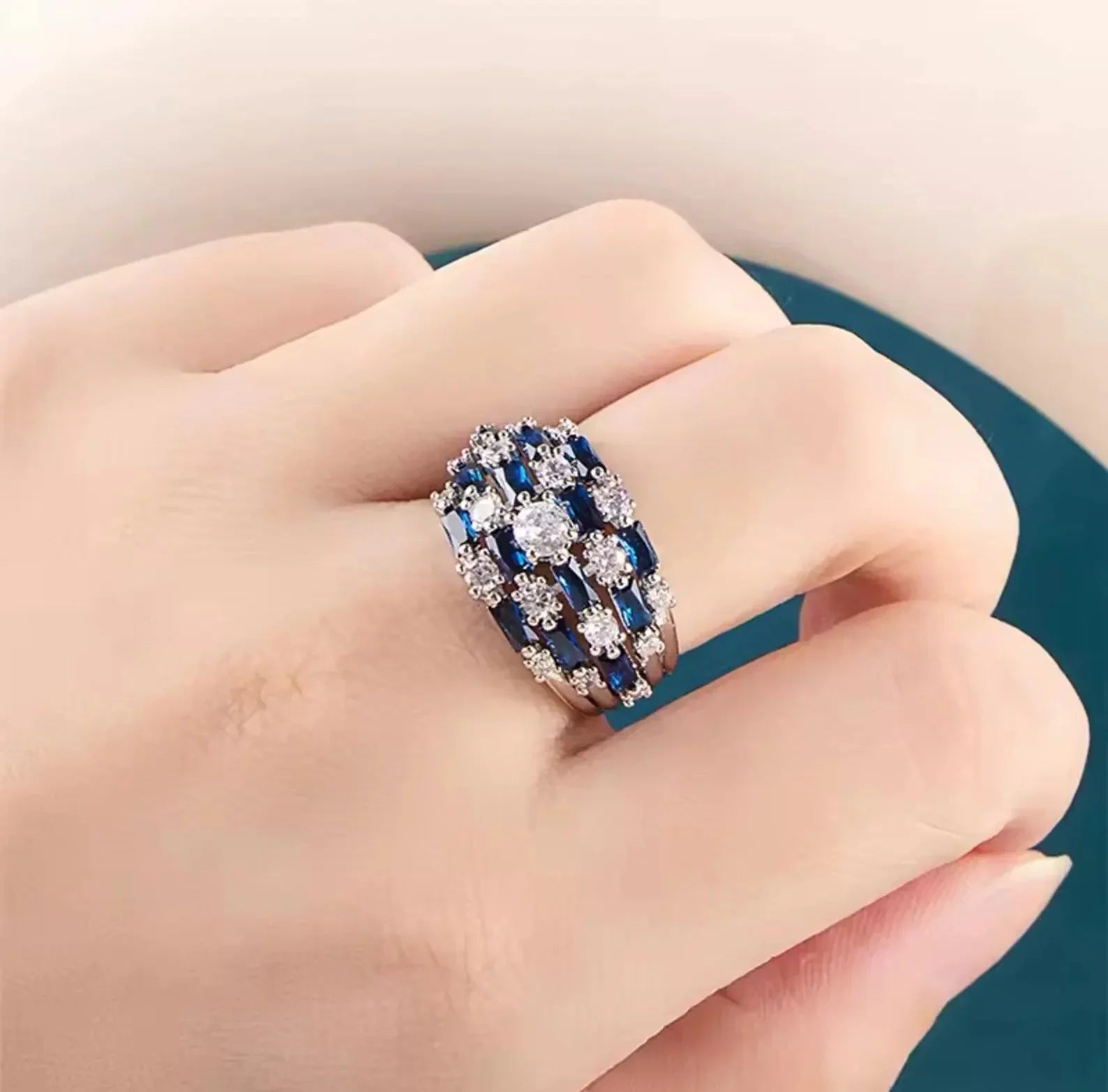 Close-up of a hand wearing a beautiful vintage-inspired sapphire and diamond statement ring.