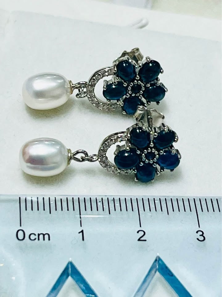 Natural blue sapphire and pearl earrings shown with a ruler for size reference.