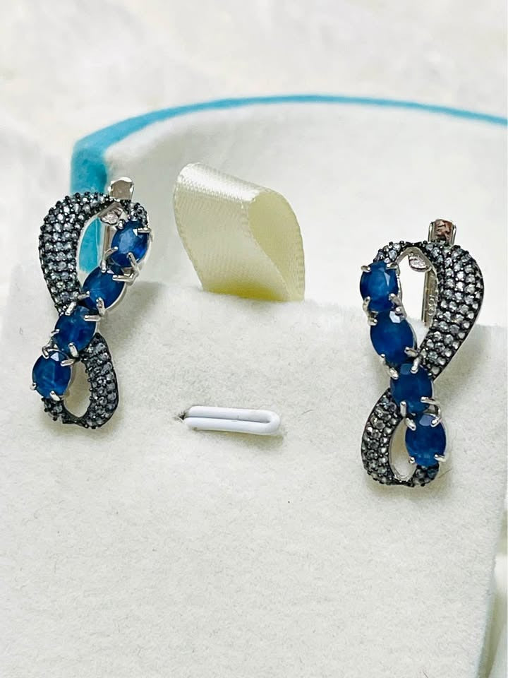 Beautiful sapphire gemstone earrings in an infinity design.