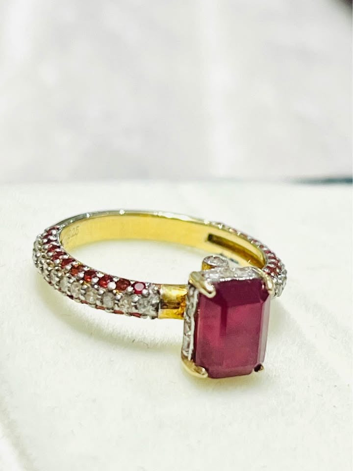 Side view of a stunning natural ruby and diamond ring.