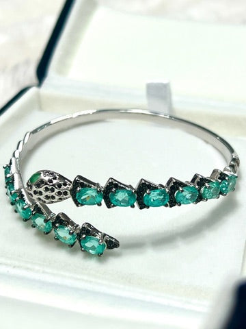 Silver snake head bracelet with apatite and Spinel gemstones angled view
