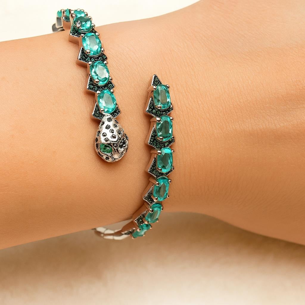 Silver snake head bracelet with apatite and Spinel gemstones on a wrist