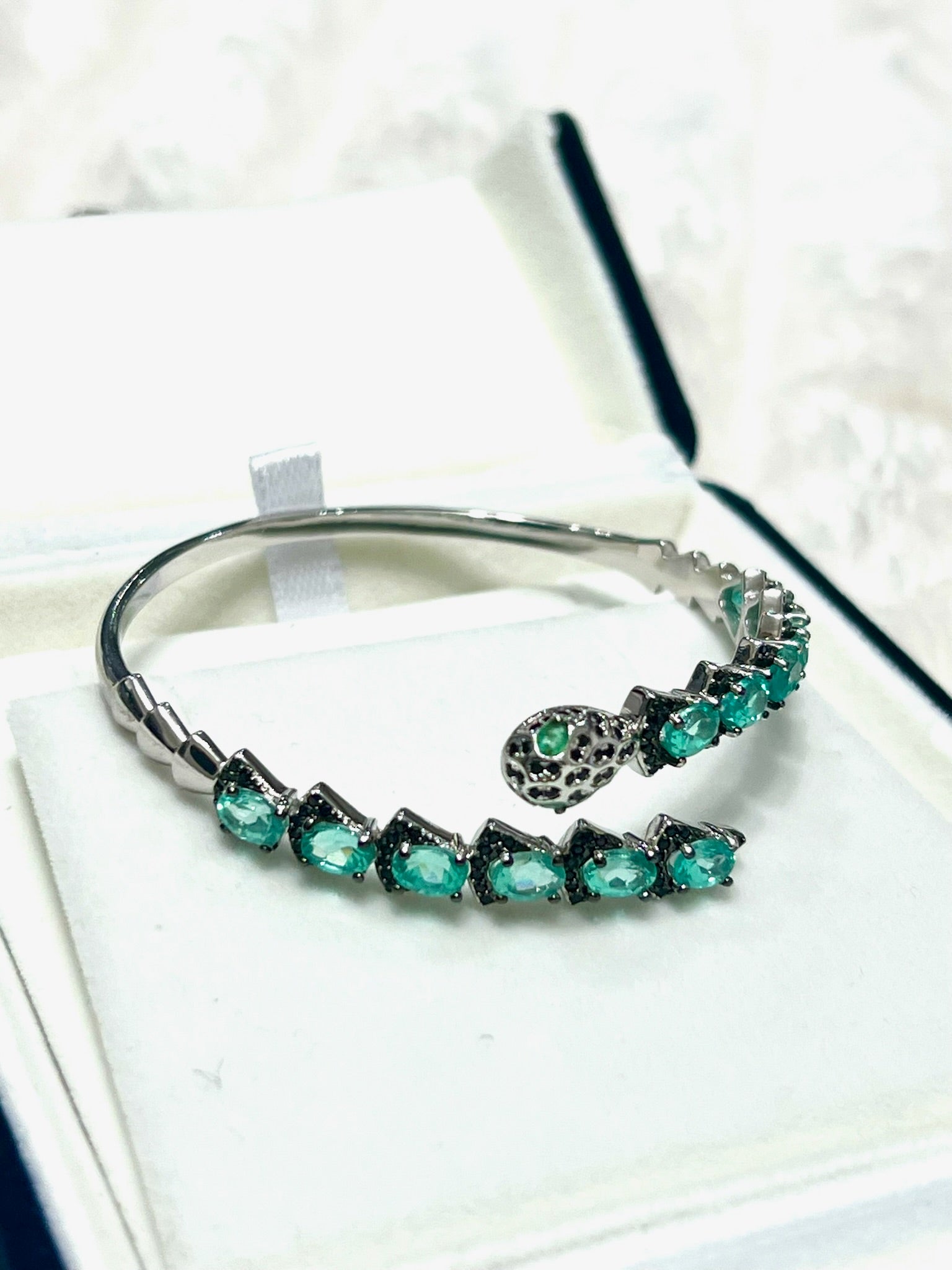 Silver snake head bracelet with apatite and Spinel gemstones in a jewelry box