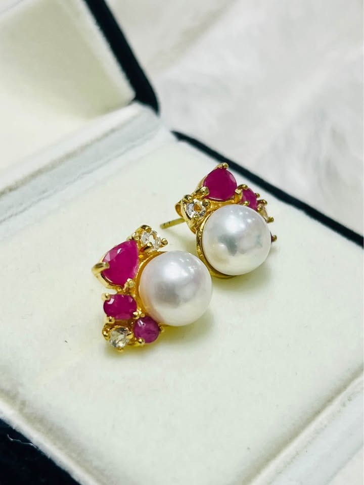 Beautiful artisan South Sea pearl earrings accented with deep red rubies and radiant white topaz