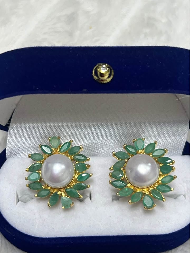 Pair of natural South Sea pearl and emerald cluster stud earrings, set in sterling silver, in a blue box.