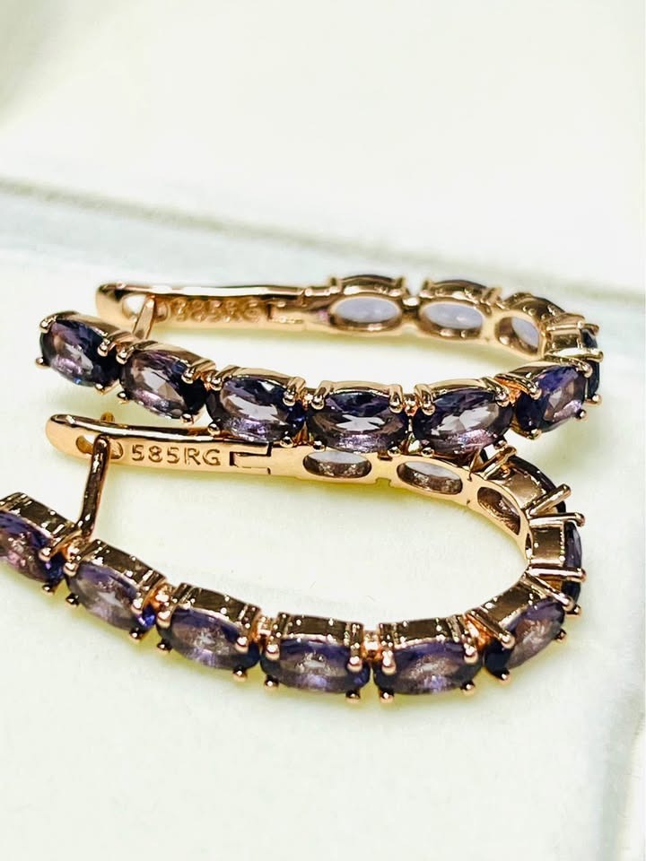 Detailed shot of 14K (585RG) stamped rose gold hoop earrings, showcasing multiple oval amethyst stones.