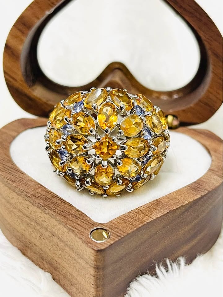 Top view of a dazzling sterling silver cluster ring featuring vibrant citrine and subtle tanzanite gemstones
