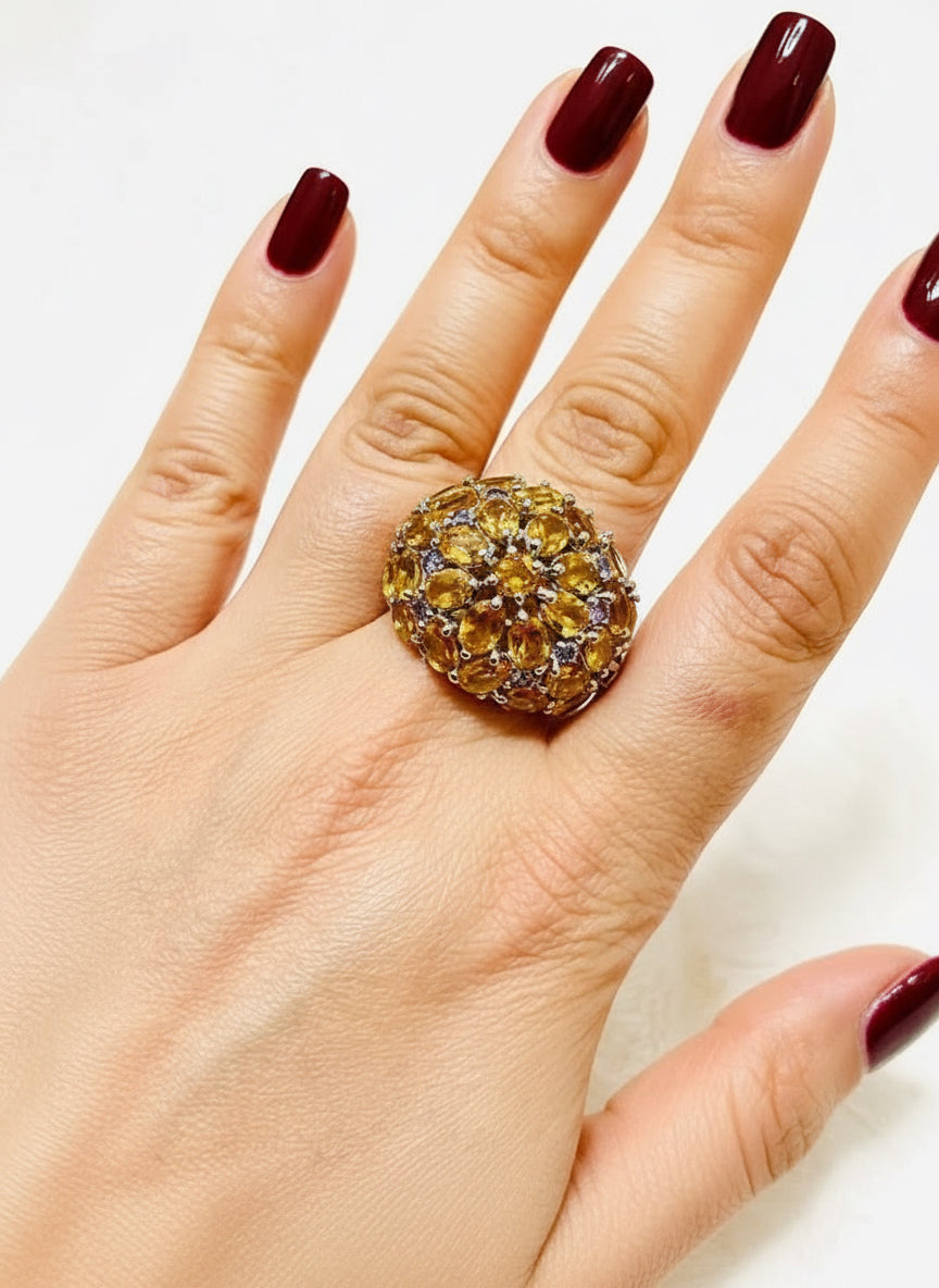 Sterling silver citrine and tanzanite statement ring worn on a hand, highlighting its bold and elegant presence