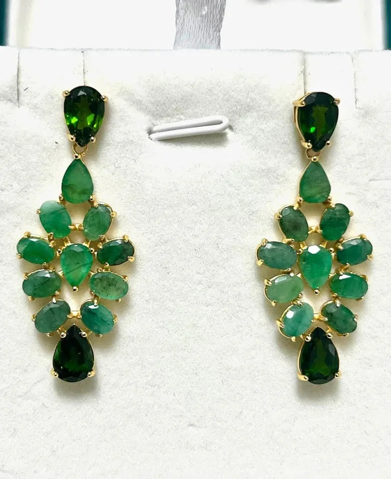 Sterling silver chandelier earrings with natural emeralds and dropside gemstones, featuring a gold-plated setting.