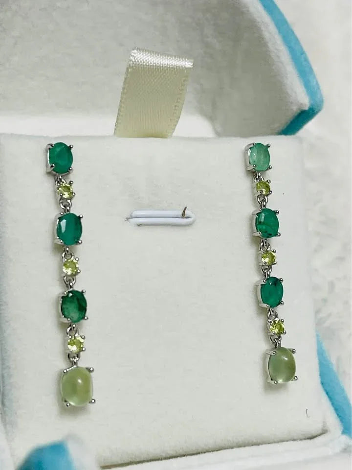 Natural sterling silver earrings with a beautiful cascade of emerald, peridot, and prehnite in an open box.