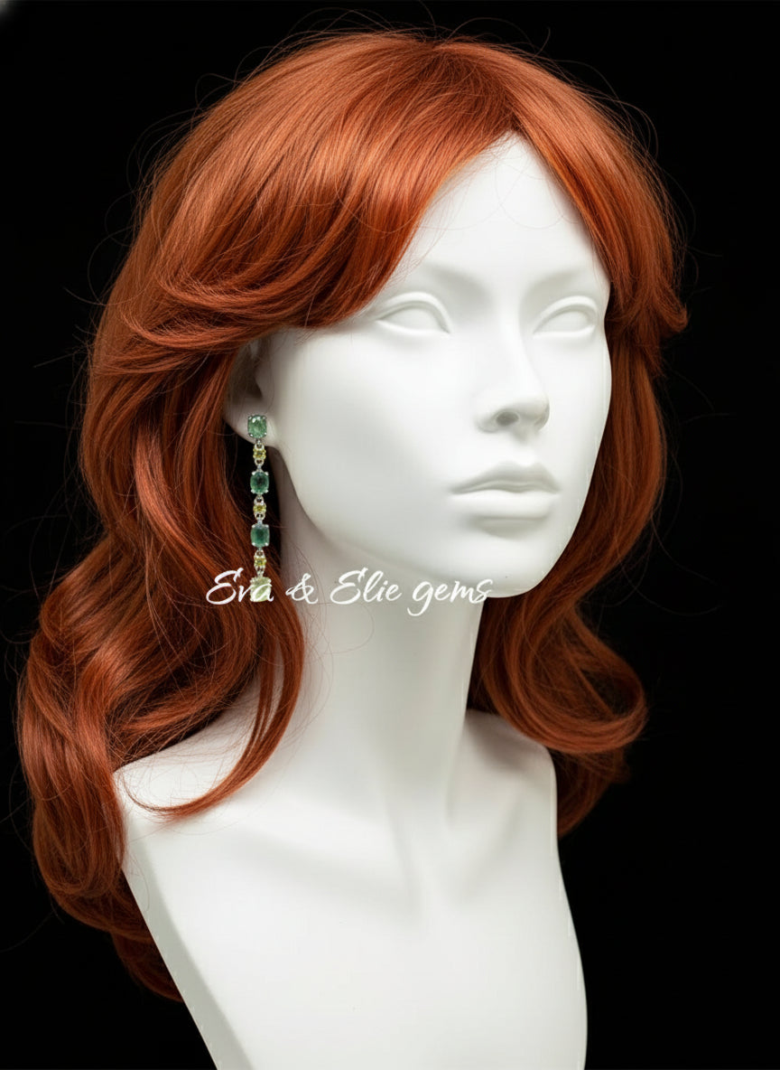 Model shot of sterling silver earrings with emerald, peridot, and prehnite gems on a mannequin ear.