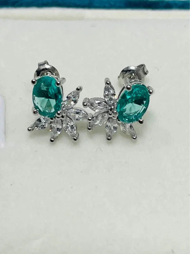 A pair of sterling silver stud earrings. They feature vibrant green paraiba tourmaline and cubic zirconia flower petals.