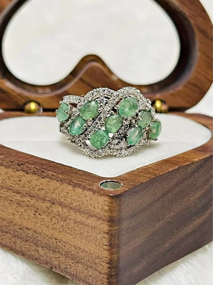 Exquisite sterling silver 925S ring featuring a vibrant cluster of natural emeralds and sparkling white stones.