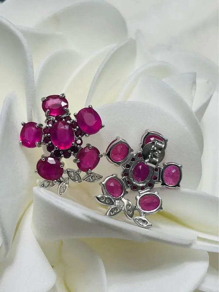 A view of the front and back of the sterling silver stud earrings with a cluster of natural pink rubies.