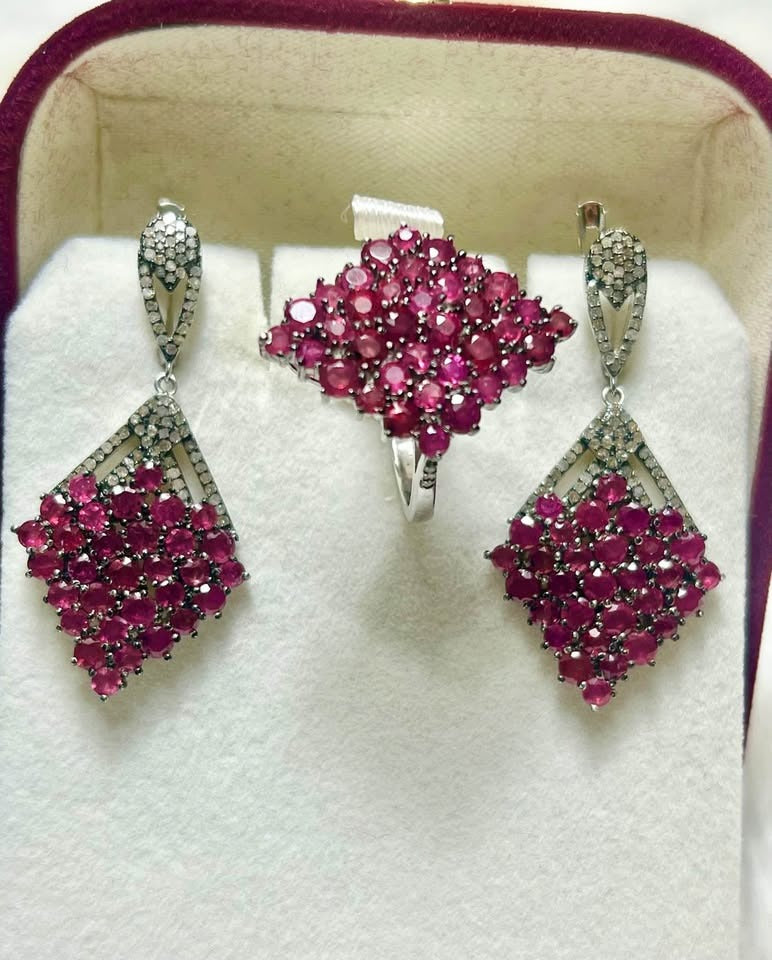 Sterling silver jewelry set with dangle earrings and a ring, both featuring clusters of natural rubies and diamonds.