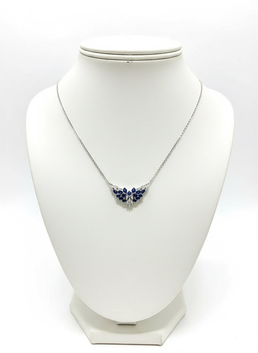 Sterling silver necklace with a natural sapphire pendant, featuring a cluster of brilliant blue sapphires on a mannequin.