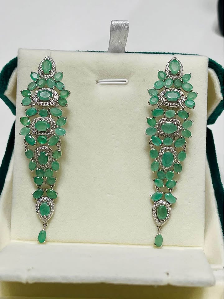  A pair of sterling silver drop earrings with multiple prong-set natural Colombian emeralds and CZ accents.