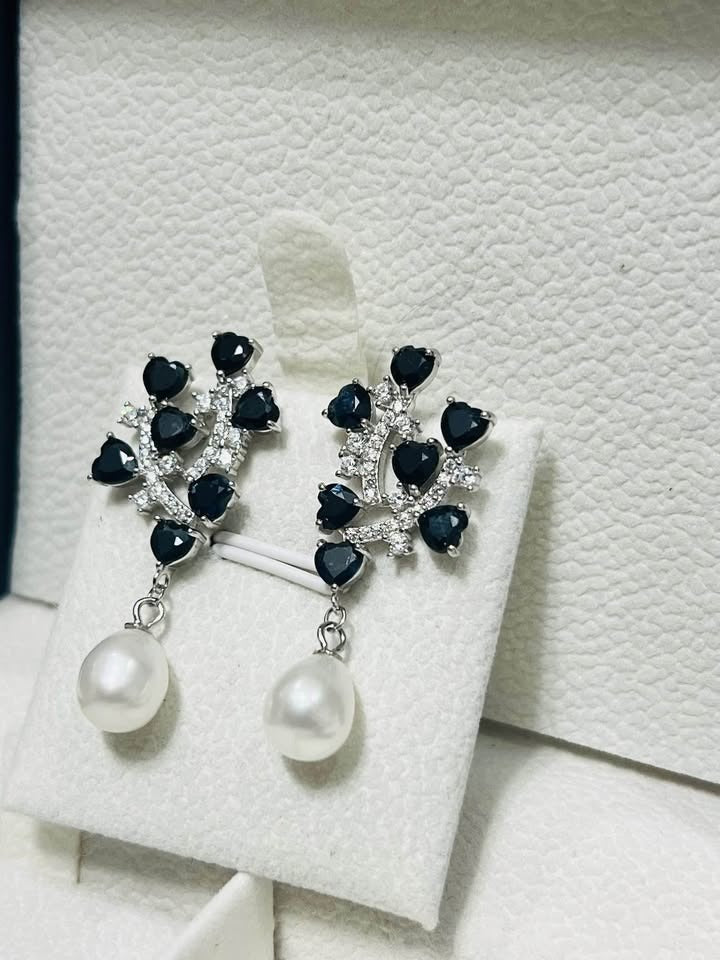  Natural sterling silver earrings featuring heart-shaped sapphires, sparkling accents, and a dangling pearl.