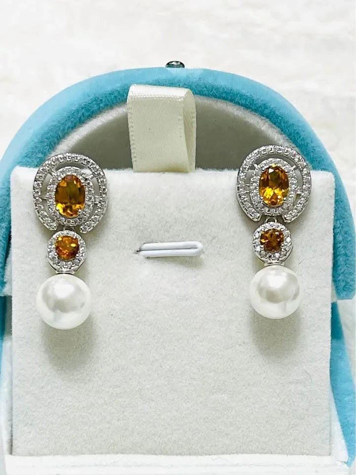Pair of stunning natural sterling silver earrings featuring golden citrine and classic white pearls in a jewelry box.