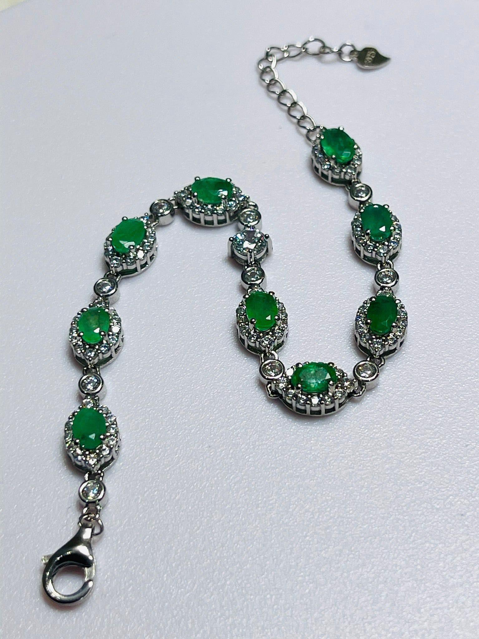 Exquisite rhodium-plated sterling silver bracelet with vibrant Colombian emeralds.