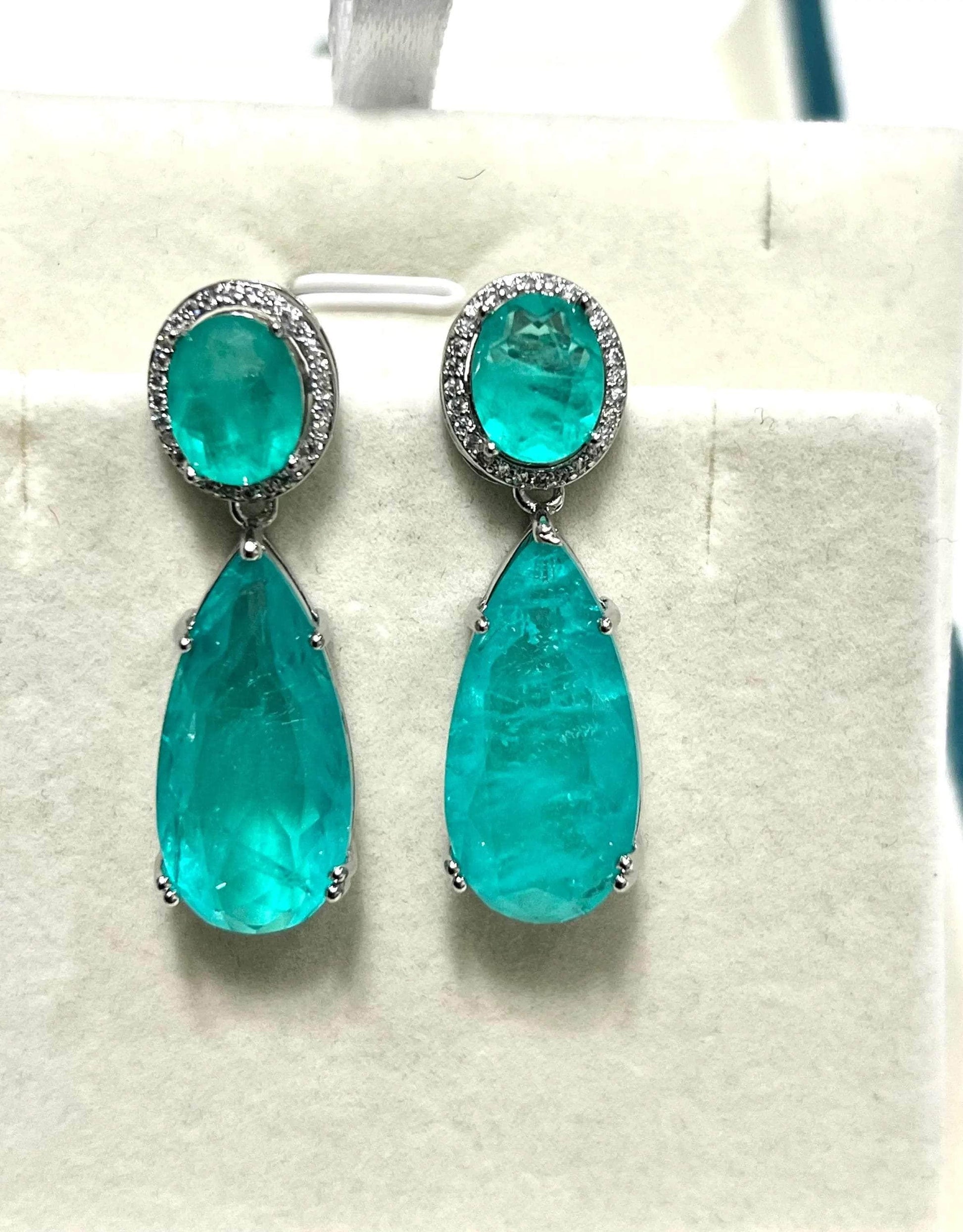 Pair of exquisite teal Paraiba tourmaline teardrop earrings with a sparkling halo.