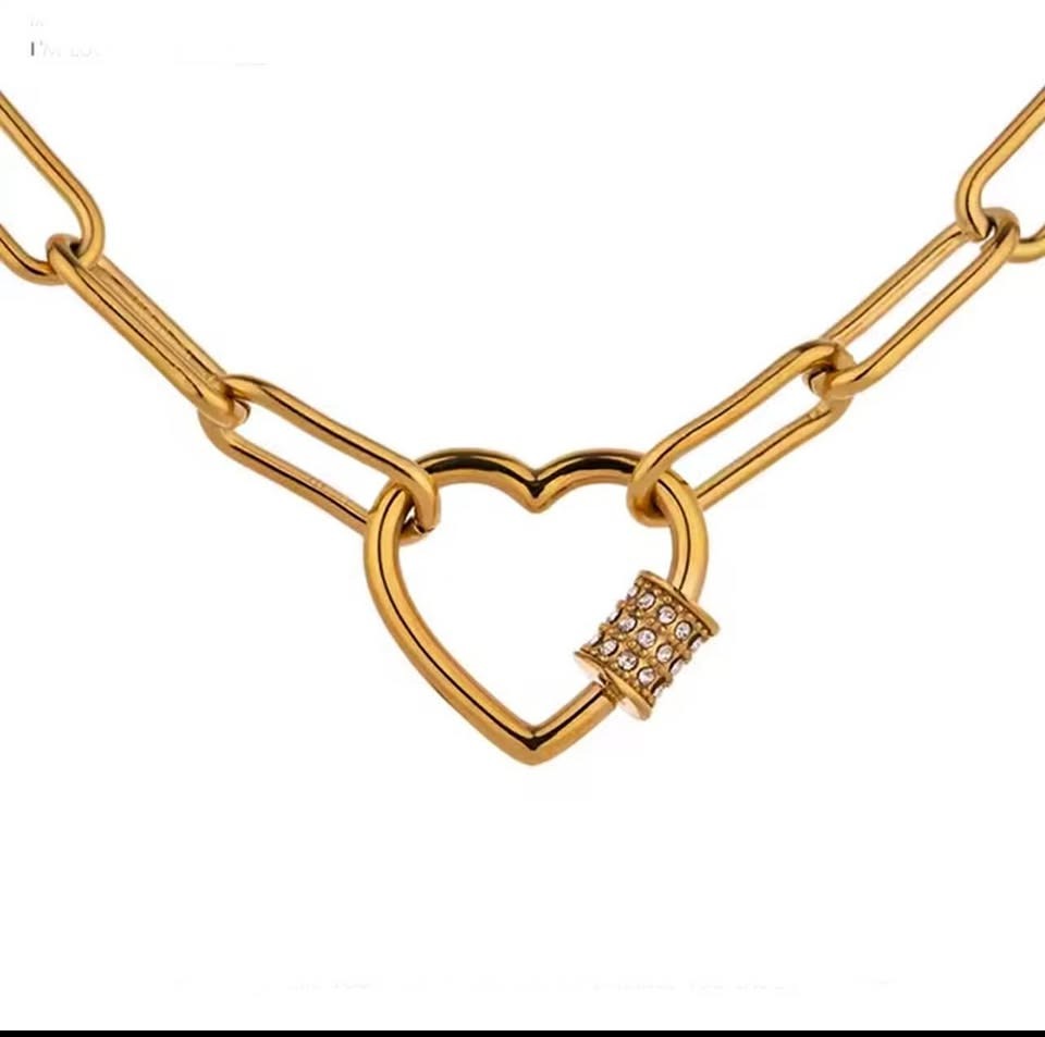 Studio shot of a vermeil paperclip chain necklace with an elegant heart-shaped pave clasp.